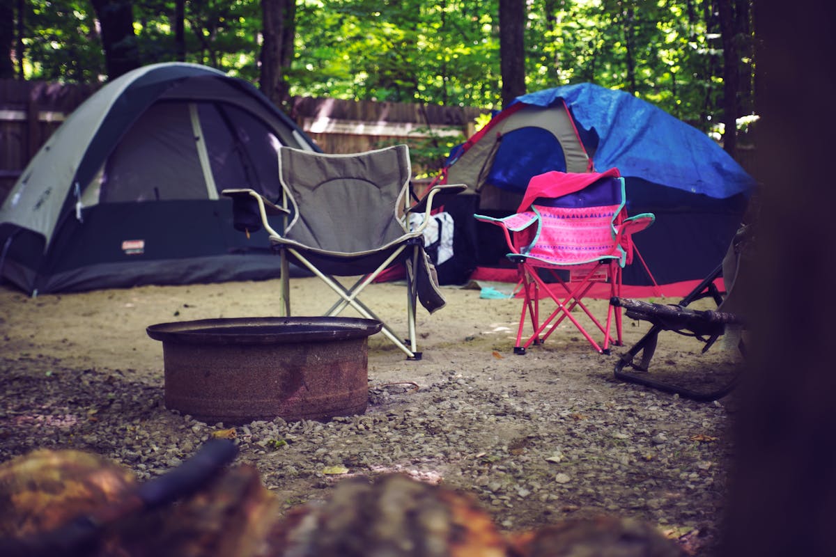 Sleeping pad inside a tent at sunrise with hiking gear nearby