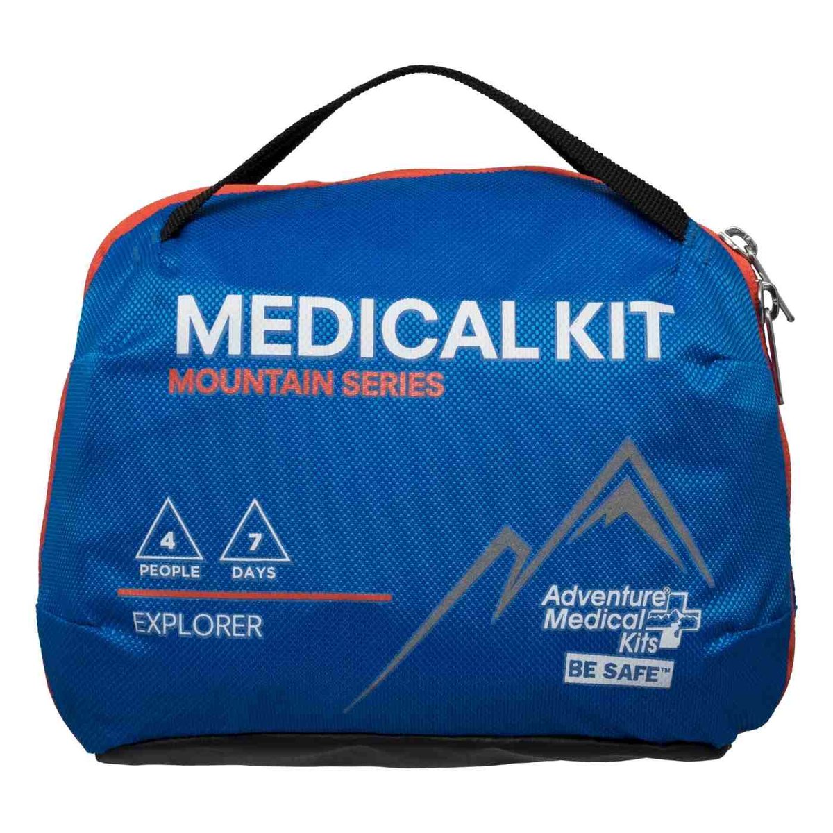 Dog first aid kit opened on a rock at a campsite with gauze, tweezers, and paw balm visible