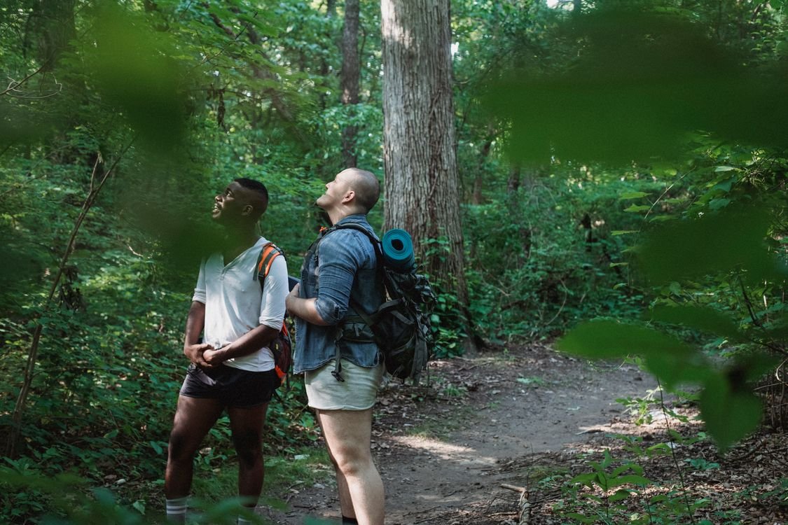 Hiker with daypack on a mountain trail overlooking a valley