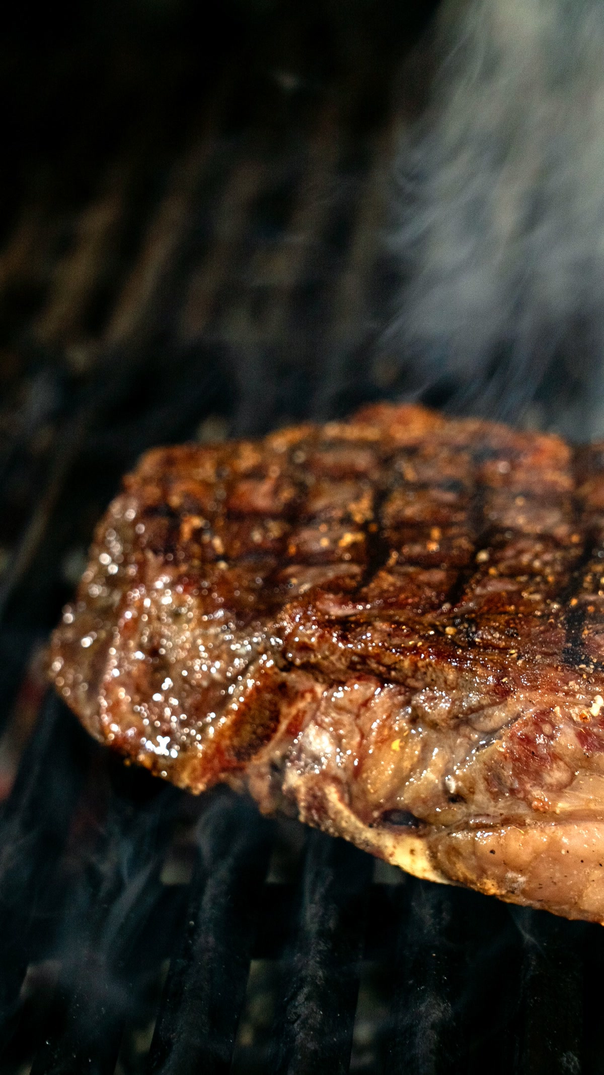 Close-up of sear marks on a steak on a portable grill grate