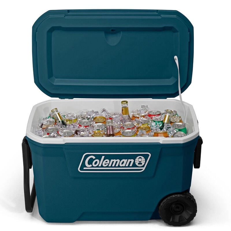 Coleman 316 series wheeled cooler sitting at a family campsite with food and drinks being unloaded