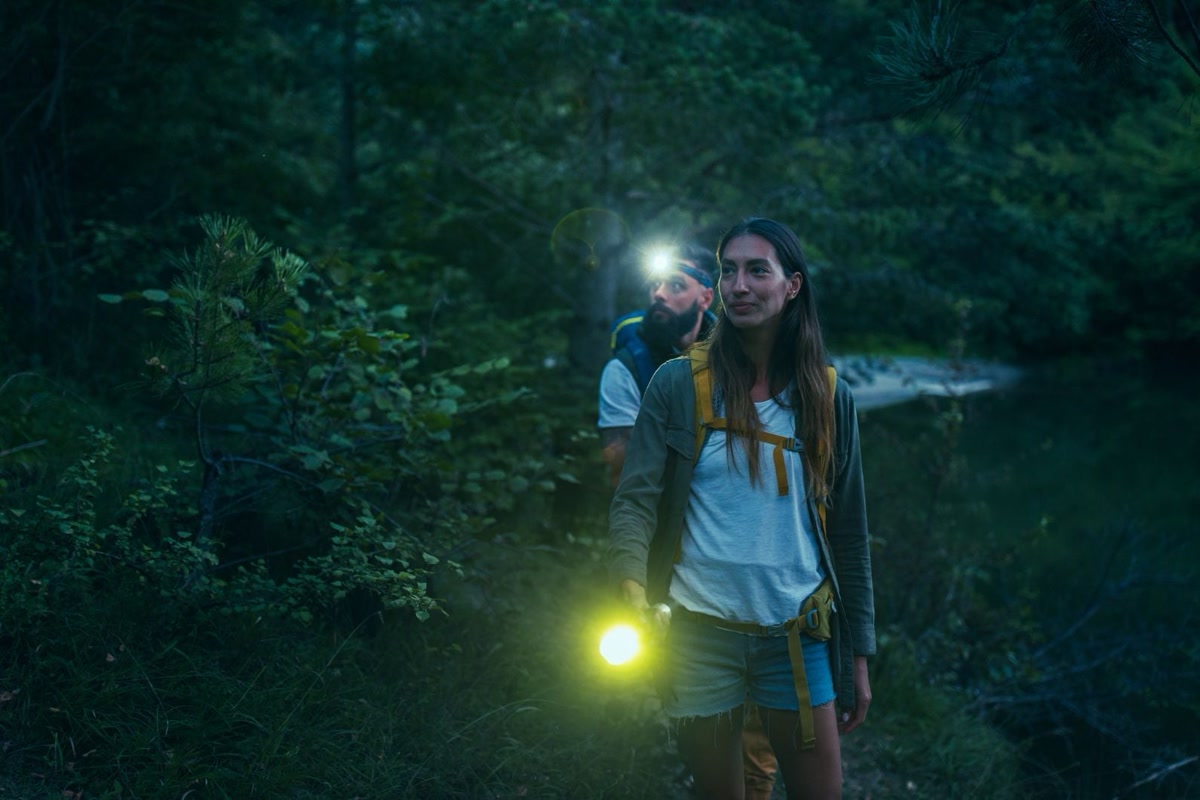 Headlamps tested side by side on a dark trail at night