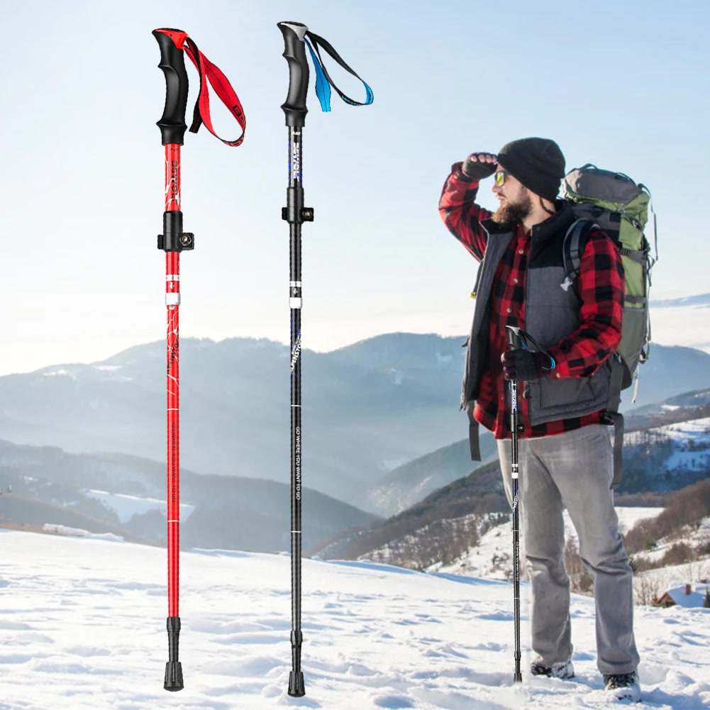 Hiker using trekking poles on a scenic mountain trail at golden hour