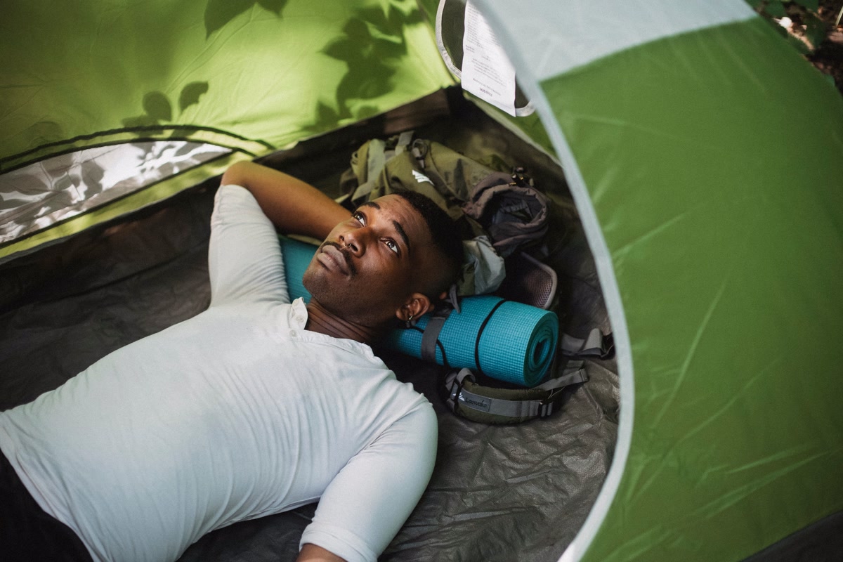 Sleeping pad set up inside a tent in the woods at dawn