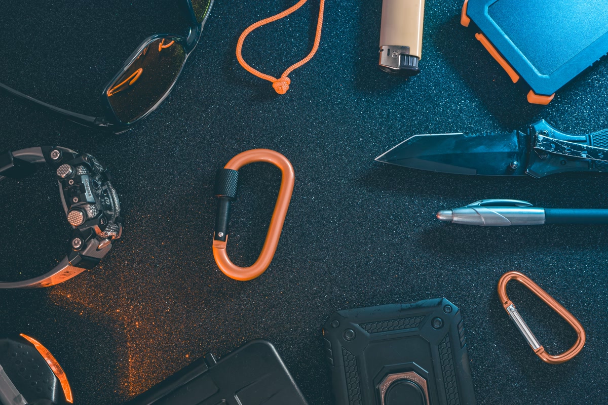 Everyday carry gear flat lay on wooden table