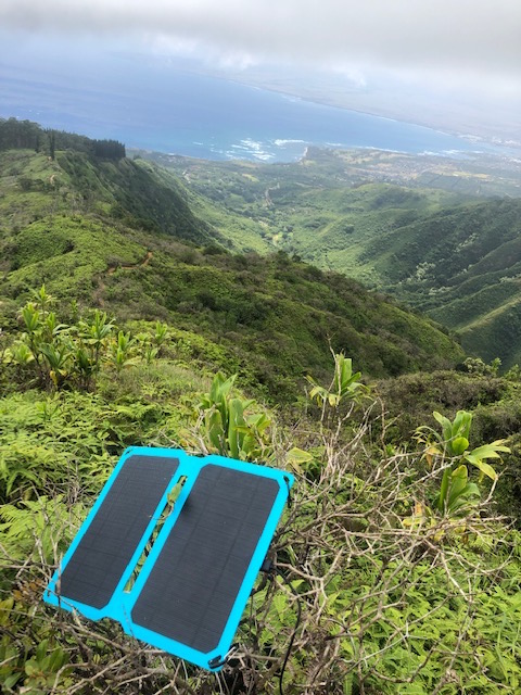 Solar panel charging devices at a mountain campsite