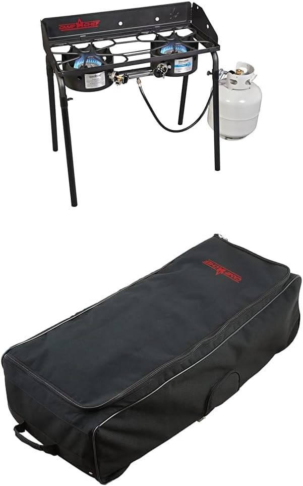 Camp Chef Explorer freestanding two-burner stove set up on its legs at a group campsite, with a larg