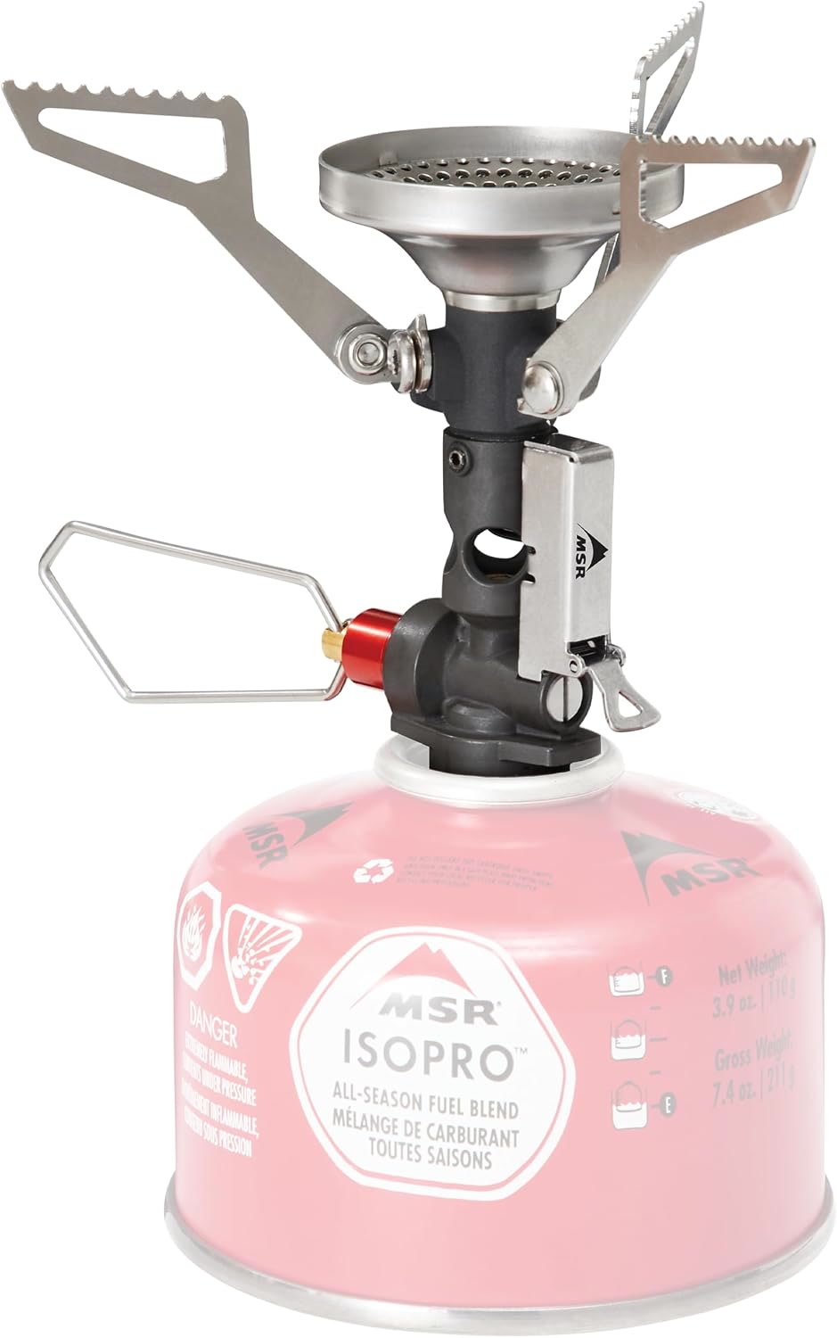 MSR PocketRocket Deluxe canister stove with a small titanium pot boiling water, set on a flat rock a