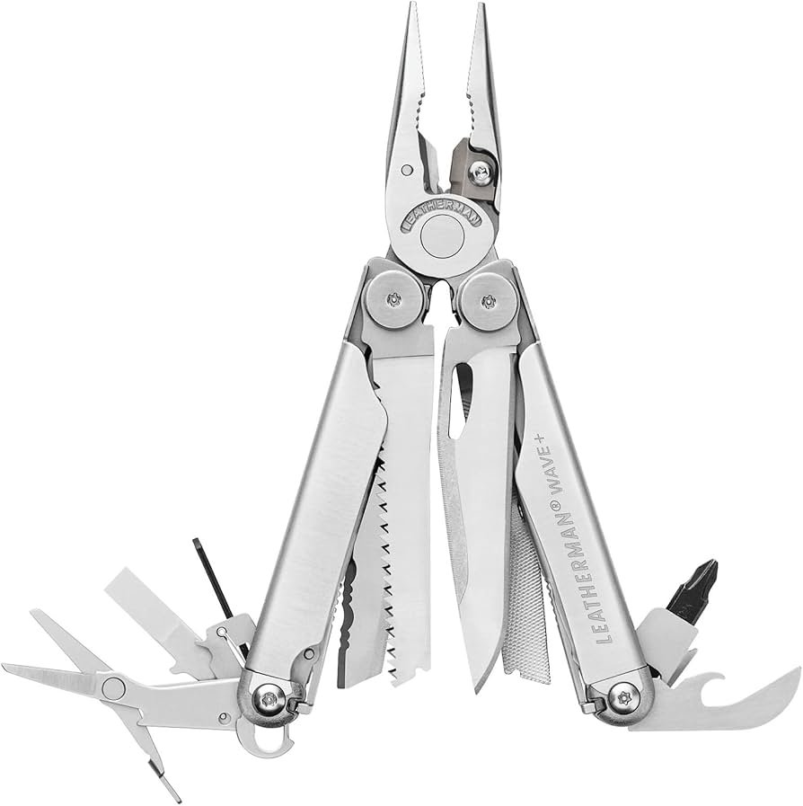 Leatherman multitool opened to show pliers and knife blade on a rock surface