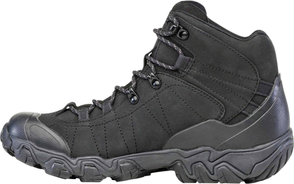 Oboz Bridger Mid hiking boot on a rocky scree field with mountain peaks in the background